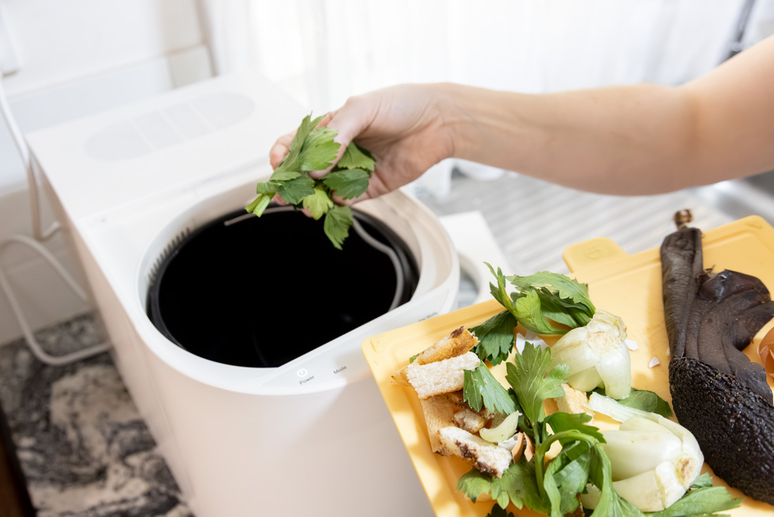 Adding food scraps into the Soilux kitchen composter